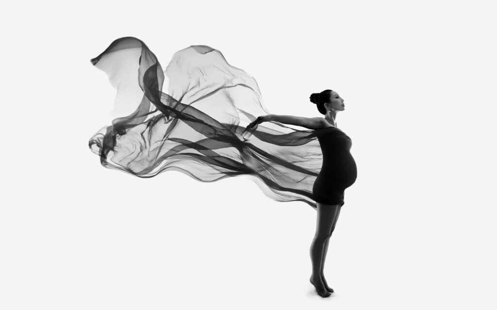 Beautiful artistic maternity silhouette with sheer flowing fabric. NYC and Miami photography by Lola Melani
